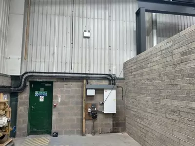 Part of the new pipework infrastructure installed at the Tamworth facility. This section shows three stacked pipework runs routed through the building &mdash; two high-pressure lines supplying the wash bay and one low-pressure feed serving the pressure washin